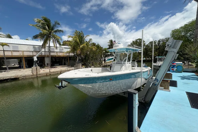 The Image of 2021 Sea Fox 268 Commander boat docked by a tropical waterfront with palm trees. - 1