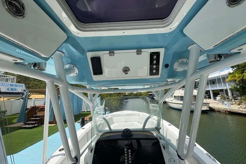 Slide: The Image of Interior view of a 2021 Sea Fox 268 Commander boat, showcasing helm and overhead console. - 10