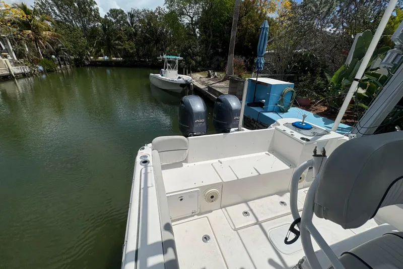 Slide: The Image of 2021 Sea Fox 268 Commander boat docked on a serene waterway with lush greenery. - 11