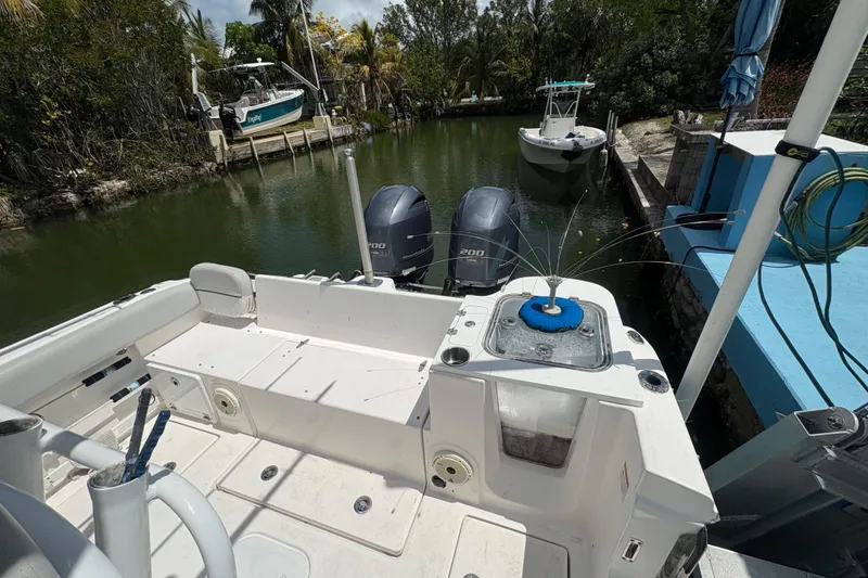Slide: The Image of 2021 Sea Fox 268 Commander boat docked, featuring dual engines and spacious deck. - 12