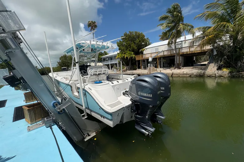 Slide: The Image of 2021 Sea Fox 268 Commander boat docked with dual Yamaha engines, surrounded by tropical scenery. - 3