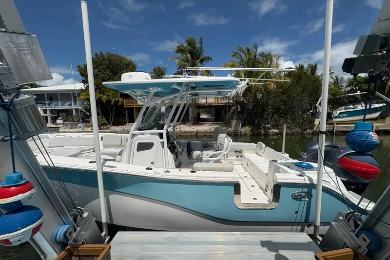 Slide: The Image of 2021 Sea Fox 268 Commander boat docked, featuring sleek design and spacious deck. - 4