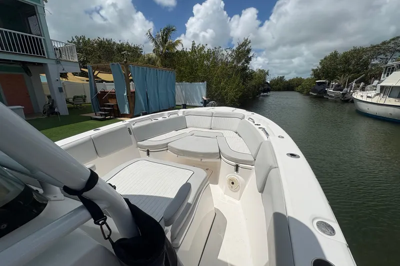 Slide: The Image of 2021 Sea Fox 268 Commander boat docked on a serene canal under a cloudy sky. - 6