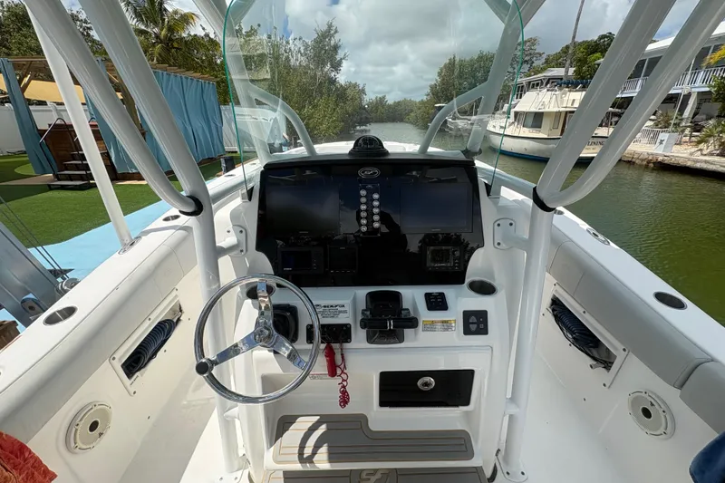 Slide: The Image of 2021 Sea Fox 268 Commander boat cockpit with steering wheel and navigation controls. - 9