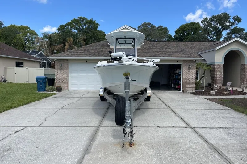 The Image of 2020 Sea Hunt BX 25 FS boat on trailer in residential driveway. - 0
