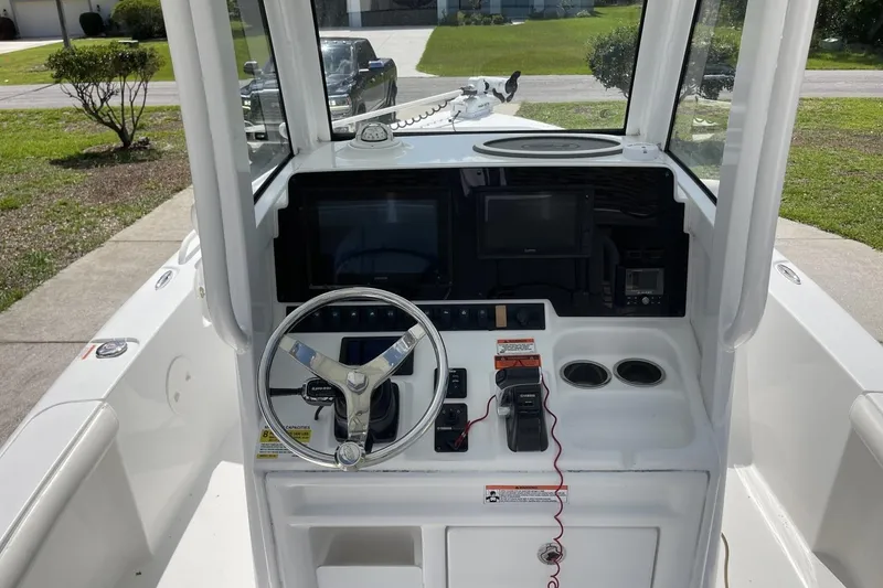 Slide: The Image of 2020 Sea Hunt BX 25 FS boat console with steering wheel and electronic controls. - 21