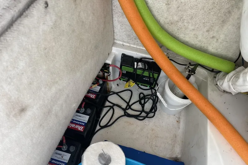 Slide: The Image of 2020 Sea Hunt BX 25 FS boat interior showing battery setup and storage area. - 22