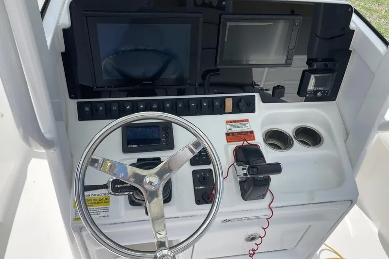 Slide: The Image of 2020 Sea Hunt BX 25 FS boat dashboard with steering wheel and electronic displays. - 25