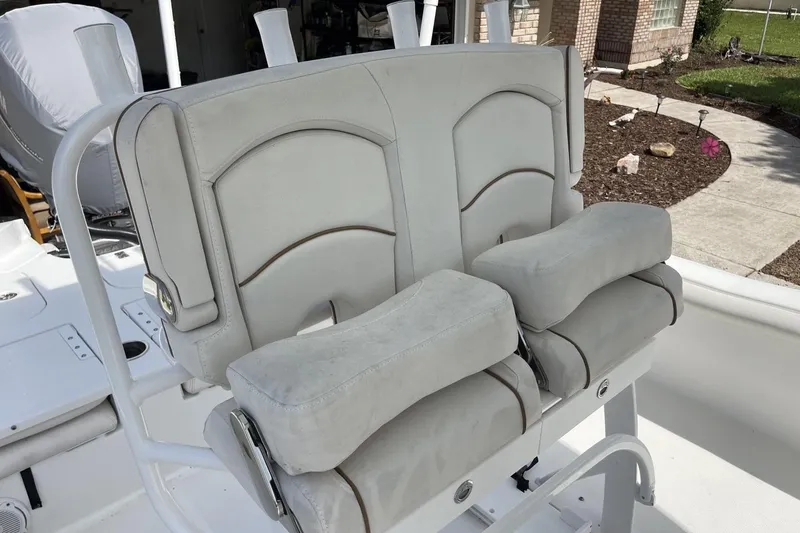 Slide: The Image of 2020 Sea Hunt BX 25 FS boat seating with cushioned armrests and white upholstery. - 27
