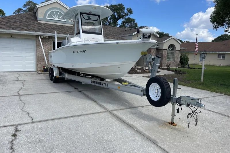 Slide: The Image of 2020 Sea Hunt BX 25 FS boat on trailer in residential driveway. - 3