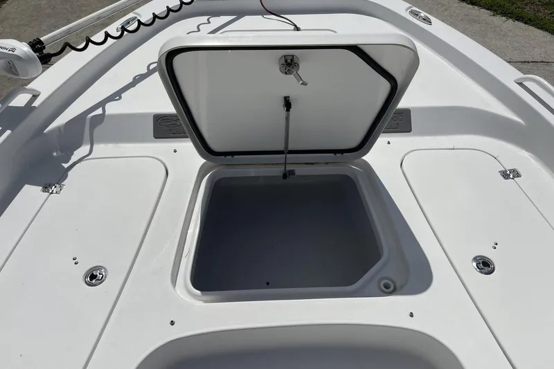 Slide: The Image of 2020 Sea Hunt BX 25 FS boat with open storage compartment on deck. - 32