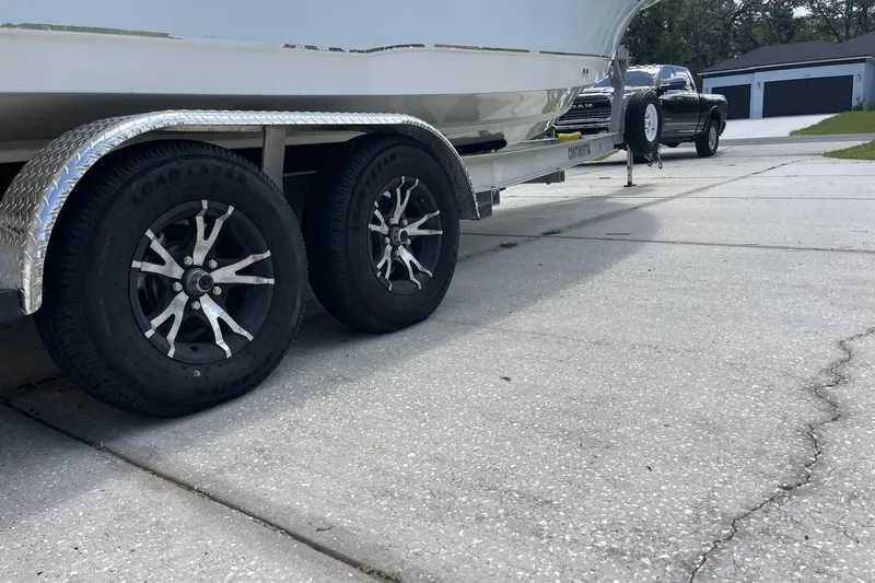 Slide: The Image of Trailer with 2020 Sea Hunt BX 25 FS boat, parked on a concrete driveway. - 5