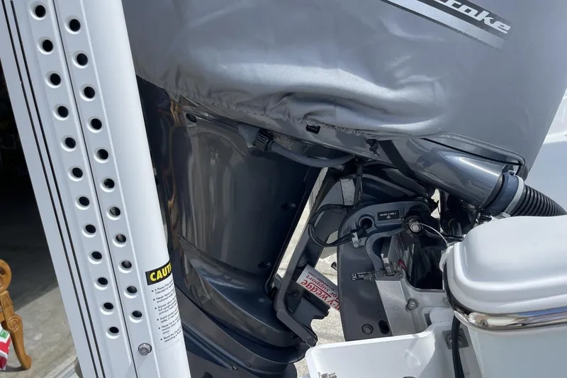 Slide: The Image of Outboard motor of a 2020 Sea Hunt BX 25 FS boat, partially covered. - 6