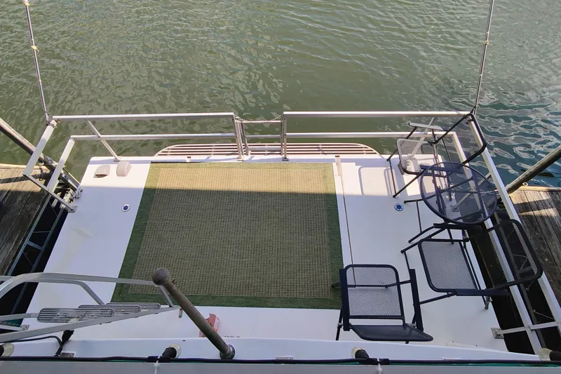 Slide: The Image of Rear deck of a 1988 Gibson 50 Standard boat with chairs and water view. - 14