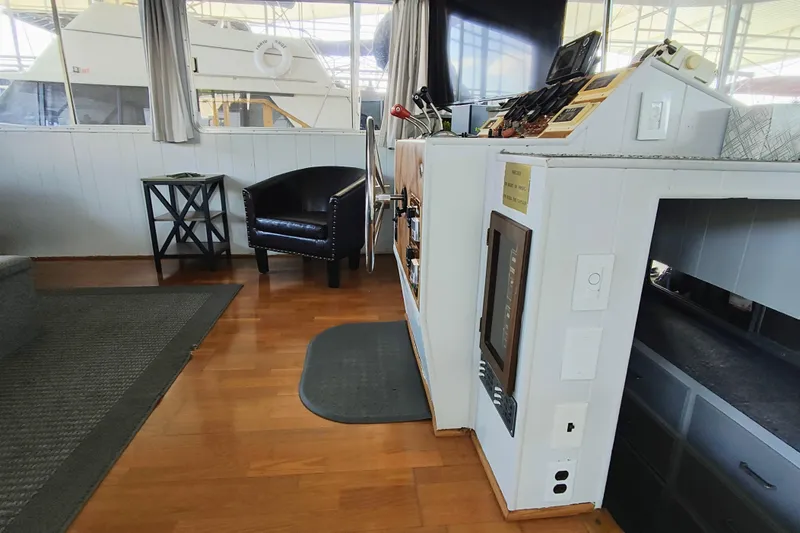 Slide: The Image of Interior of a 1988 Gibson 50 Standard boat with wooden flooring and leather chair. - 16