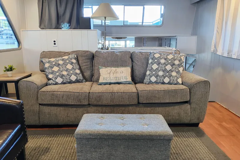 Slide: The Image of Cozy living room with a gray sofa, patterned pillows, and a decorative ottoman. - 23