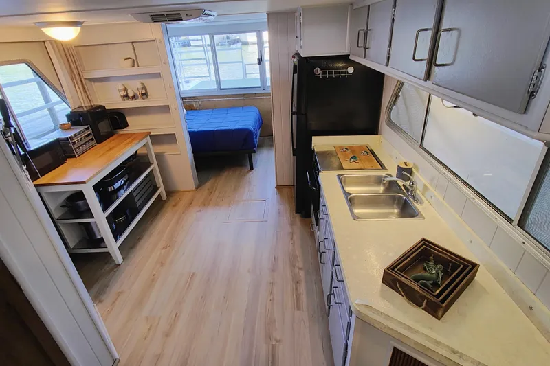 Slide: The Image of Interior of a 1988 Gibson 50 Standard houseboat with kitchen and bedroom. - 25