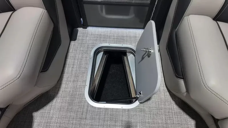 Slide: The Image of Barletta Lusso L23UC 2026, open floor storage compartment between seats. - 29