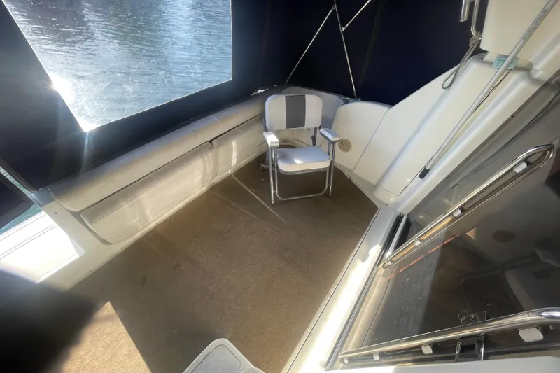 Slide: The Image of 1995 Silverton 36 Convertible boat interior with chair and window view. - 10