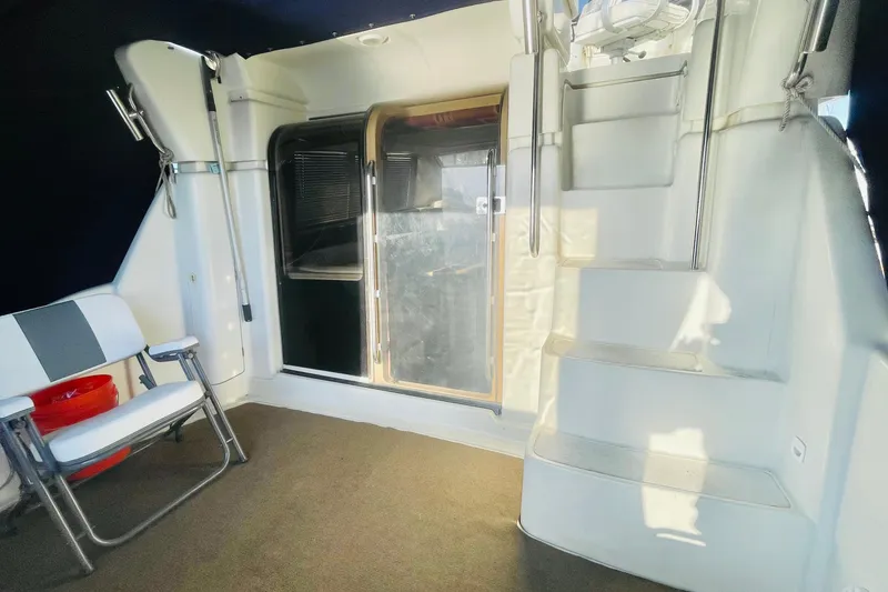 Slide: The Image of Interior view of 1995 Silverton 36 Convertible yacht with seating and stairs. - 11