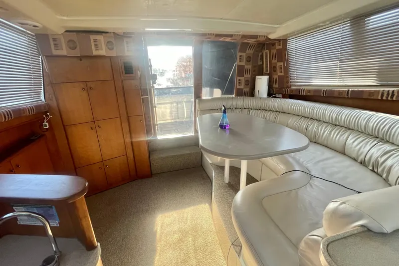 Slide: The Image of Interior of 1995 Silverton 36 Convertible yacht with plush seating and wooden cabinetry. - 13