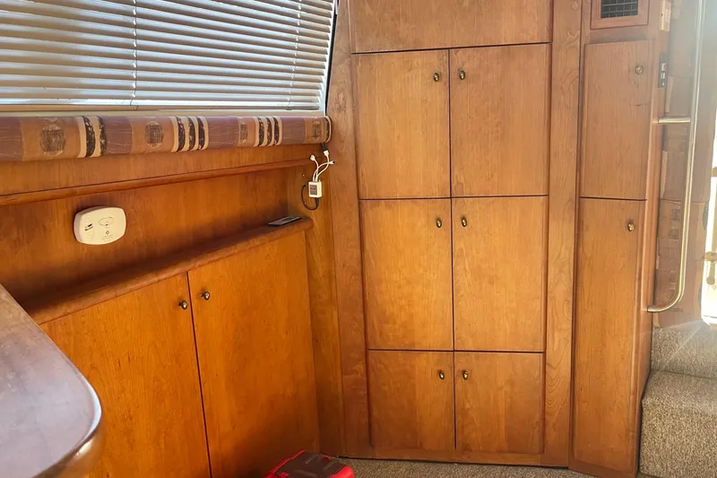 Slide: The Image of Interior of a 1995 Silverton 36 Convertible boat with wooden cabinets and blinds. - 14
