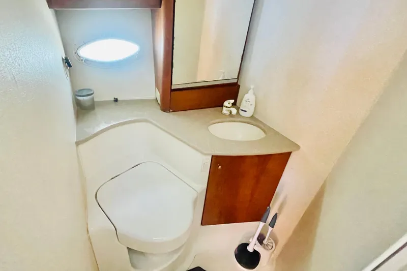 Slide: The Image of Bathroom interior of 1995 Silverton 36 Convertible yacht, featuring sink and toilet. - 18