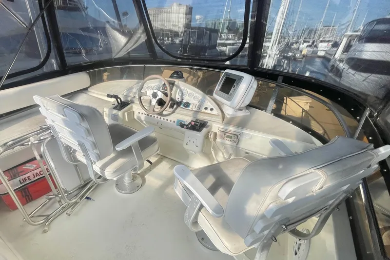 Slide: The Image of 1995 Silverton 36 Convertible yacht cockpit with steering wheel, navigation equipment, and seating. - 4