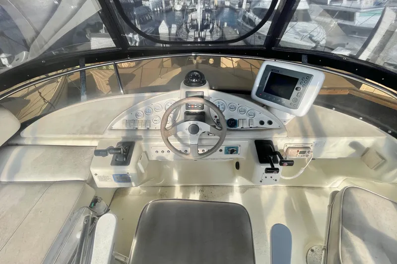 Slide: The Image of Cockpit of 1995 Silverton 36 Convertible boat with steering wheel and navigation equipment. - 5