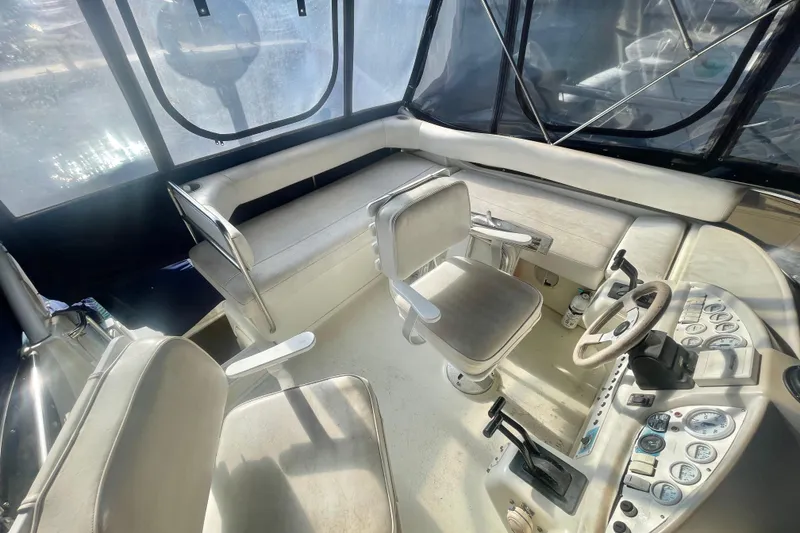 Slide: The Image of 1995 Silverton 36 Convertible boat interior with helm, seating, and control panel. - 6
