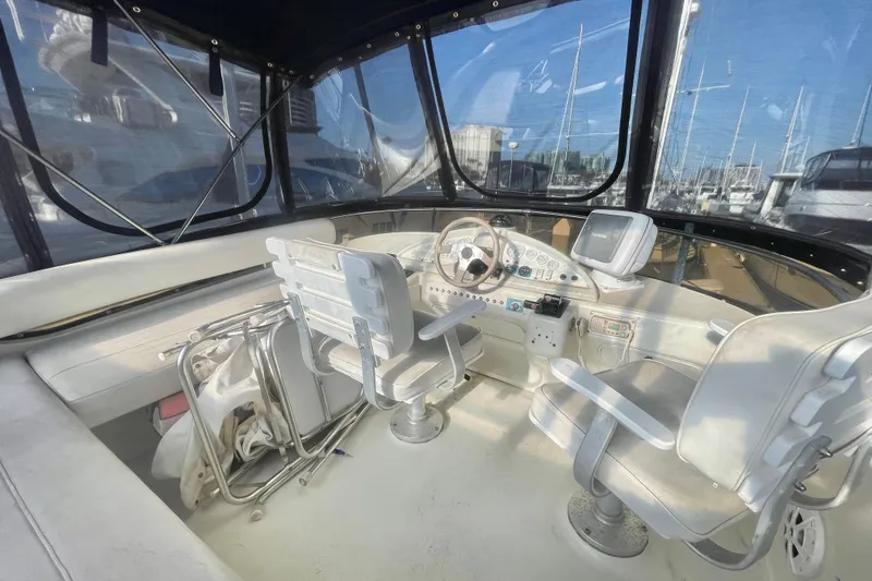 Slide: The Image of Interior helm of a 1995 Silverton 36 Convertible yacht with steering wheel and navigation equipment. - 7