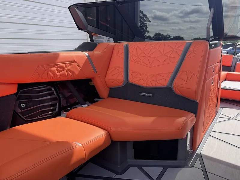 Slide: The Image of Interior of 2026 Nautique Super Air Nautique G25 Paragon with orange seating. - 11