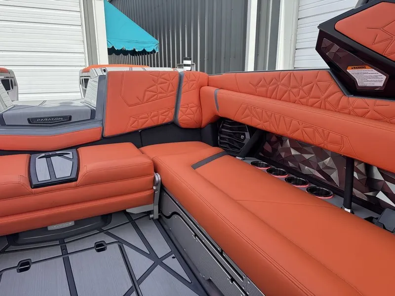 Slide: The Image of Interior of 2026 Nautique Super Air Nautique G25 Paragon with orange upholstery. - 12