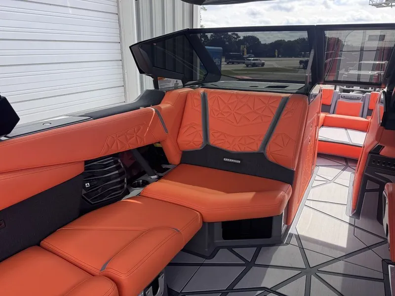 Slide: The Image of 2026 Nautique Super Air Nautique G25 Paragon interior with orange seating. - 9