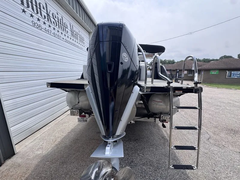 Slide: The Image of 2021 Barletta Boats 23UC with outboard motor and ladder. - 13