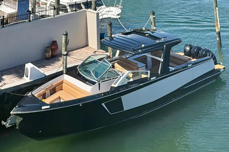 The Image of 2023 Aviara AV40 OB luxury boat docked in marina, featuring sleek design and spacious seating. - 1