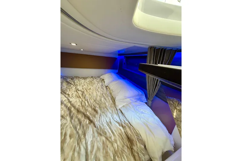 Slide: The Image of Luxurious cabin interior of 2023 Aviara AV40 OB with ambient lighting and plush bedding. - 12