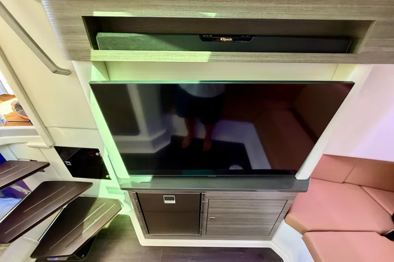 Slide: The Image of Interior of 2023 Aviara AV40 OB featuring a modern entertainment system with TV and soundbar. - 15