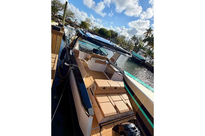 Slide: The Image of 2023 Aviara AV40 OB luxury boat docked, featuring spacious seating and sleek design. - 2