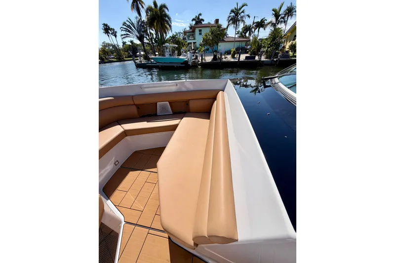 Slide: The Image of 2023 Aviara AV40 OB boat with tan seating, docked near palm trees. - 26