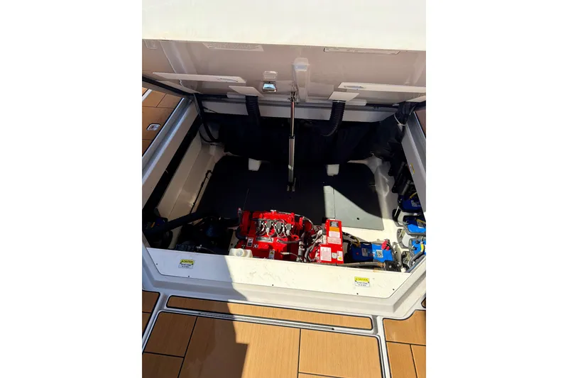 Slide: The Image of Engine compartment of 2023 Aviara AV40 OB boat, showcasing mechanical components and storage area. - 38