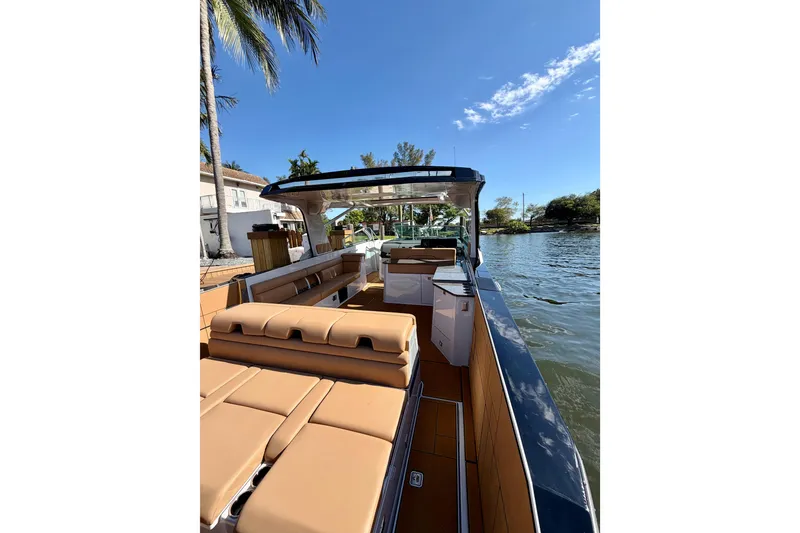 Slide: The Image of 2023 Aviara AV40 OB luxury boat with spacious seating and sleek design on a sunny day. - 42
