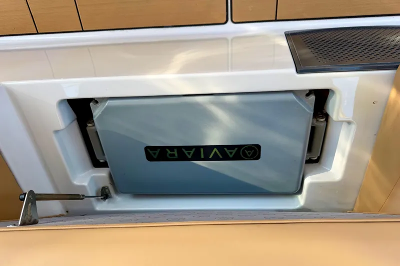 Slide: The Image of 2023 Aviara AV40 OB boat compartment with branded cover and sleek design. - 5
