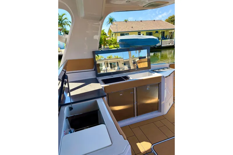 Slide: The Image of 2023 Aviara AV40 OB boat interior with modern kitchen and waterfront view. - 8