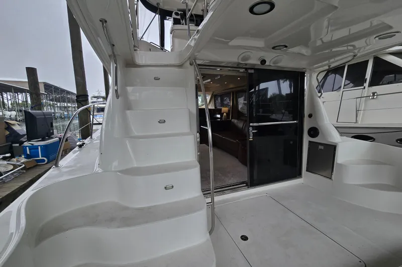 Slide: The Image of 2007 Sea Ray 52 Sedan Bridge yacht interior with stairs and seating area. - 18