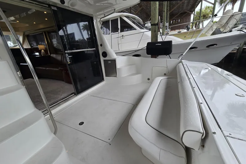 Slide: The Image of 2007 Sea Ray 52 Sedan Bridge yacht interior with seating and open cabin view. - 19