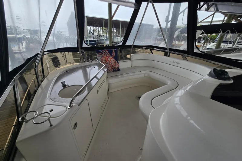 Slide: The Image of 2007 Sea Ray 52 Sedan Bridge interior with seating and sink, featuring panoramic windows. - 24