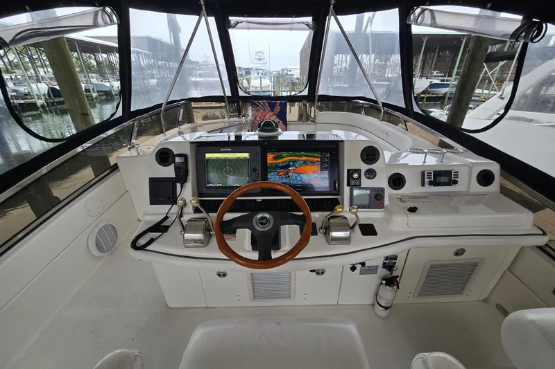 Slide: The Image of 2007 Sea Ray 52 Sedan Bridge helm with navigation screens and controls. - 28