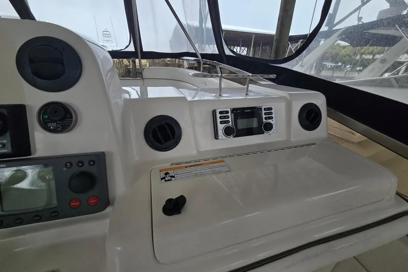 Slide: The Image of 2007 Sea Ray 52 Sedan Bridge helm with navigation controls and display panel. - 33