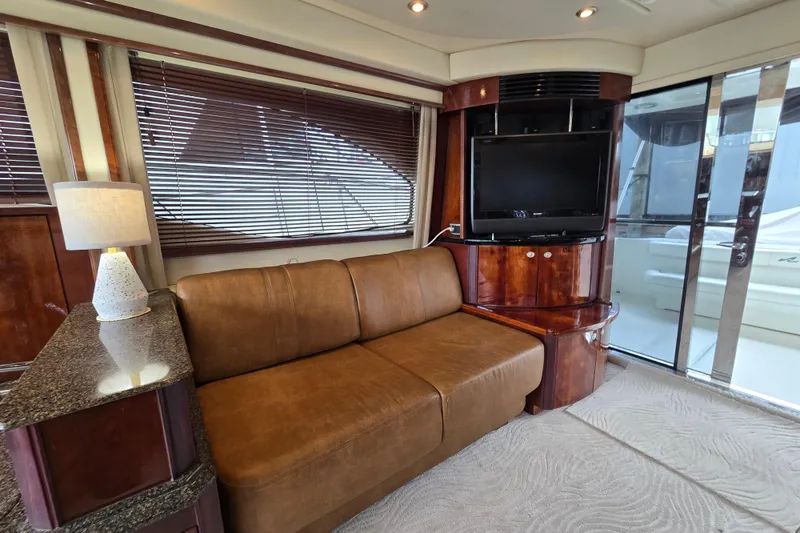 Slide: The Image of Interior of 2007 Sea Ray 52 Sedan Bridge with sofa, TV, and elegant wood finishes. - 37